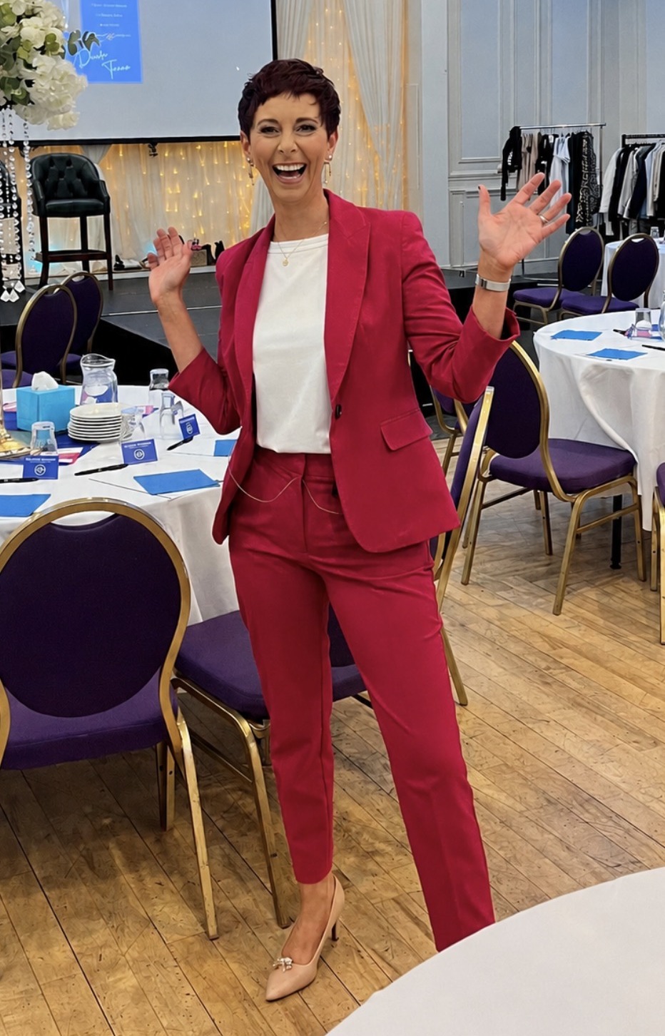 Deirdre Treanor in a cerise suit hosting a ladies' style afternoon